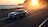Ford Mustang Mach-E tengerparti úton halad a naplementében
